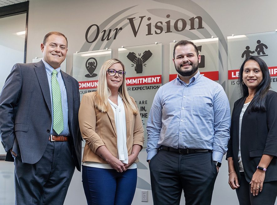 Four CFSB employees standing together smiling
