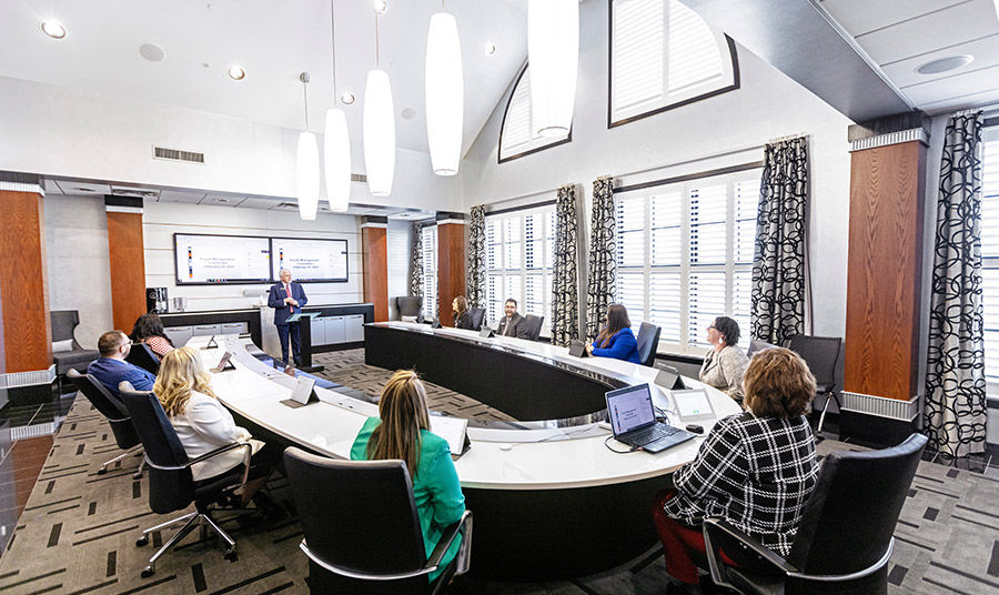 CFSB employees around a table in a meeting