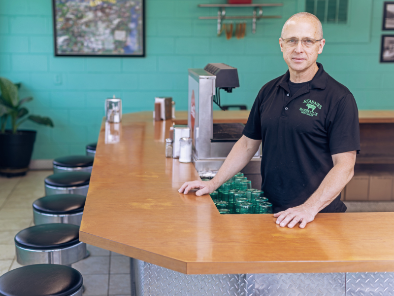 Man standing behind a counter