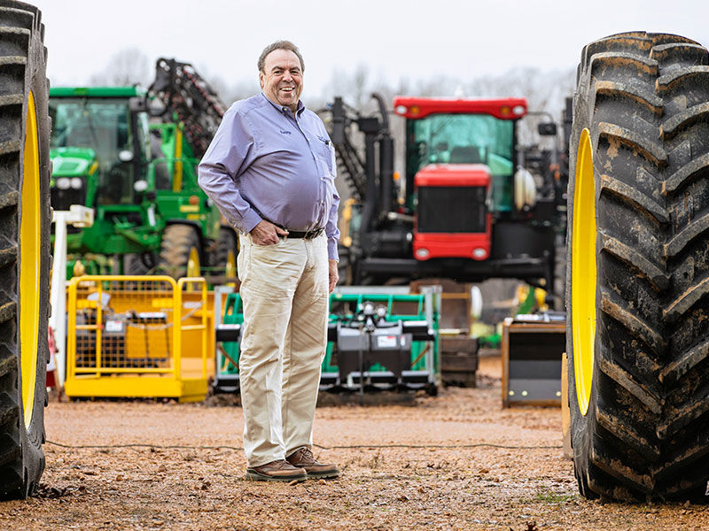 Man standing around farm equipment