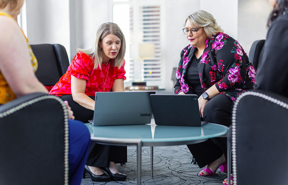 CFSB employees sitting down looking at a laptop
