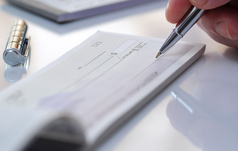 person filling out a check