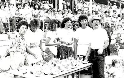 Attendees overlooking table of watermelon at the first Bank of Benton Watermelon Bust in 1974.